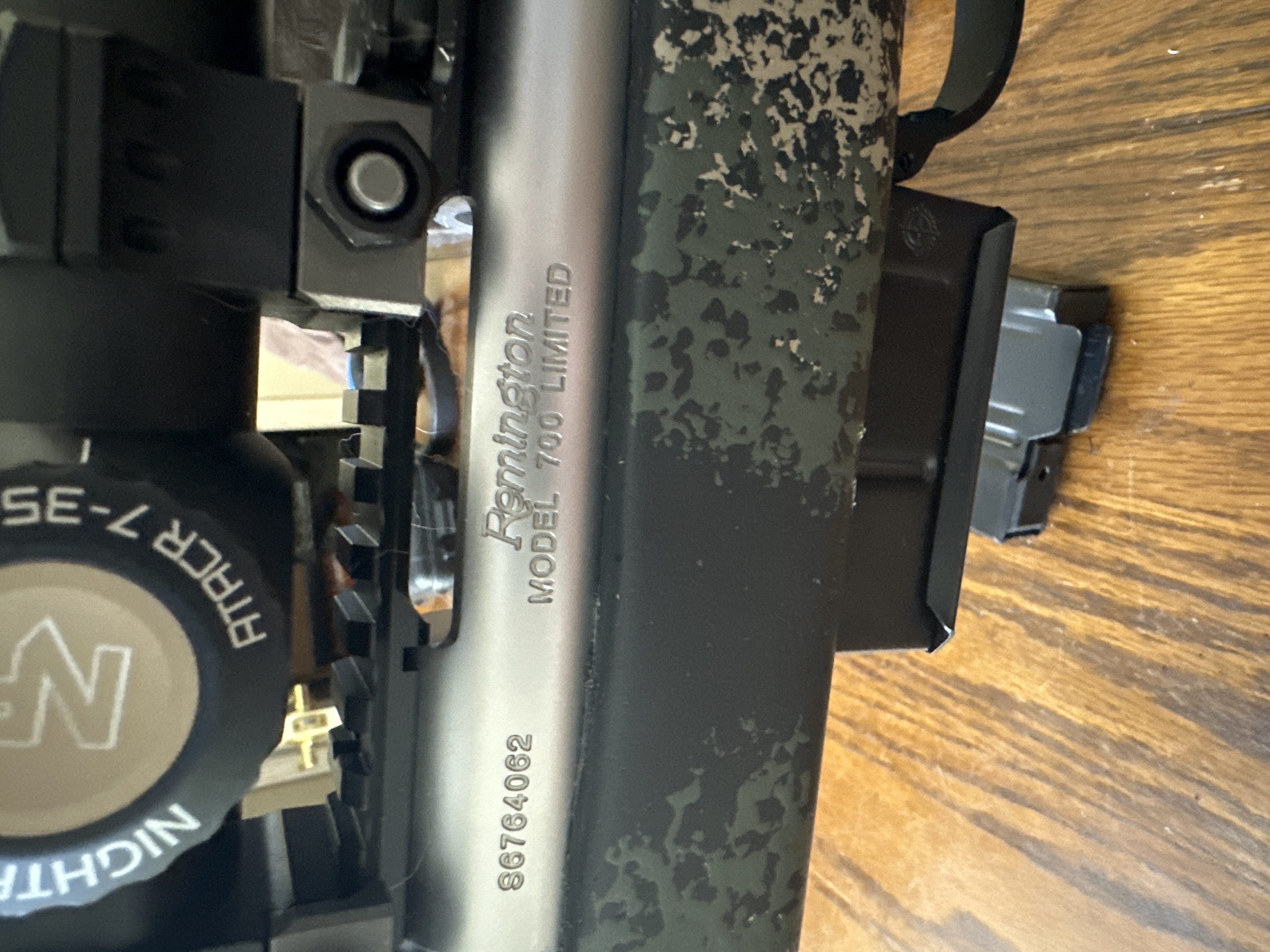 Close-up view of a precision rifle action and components